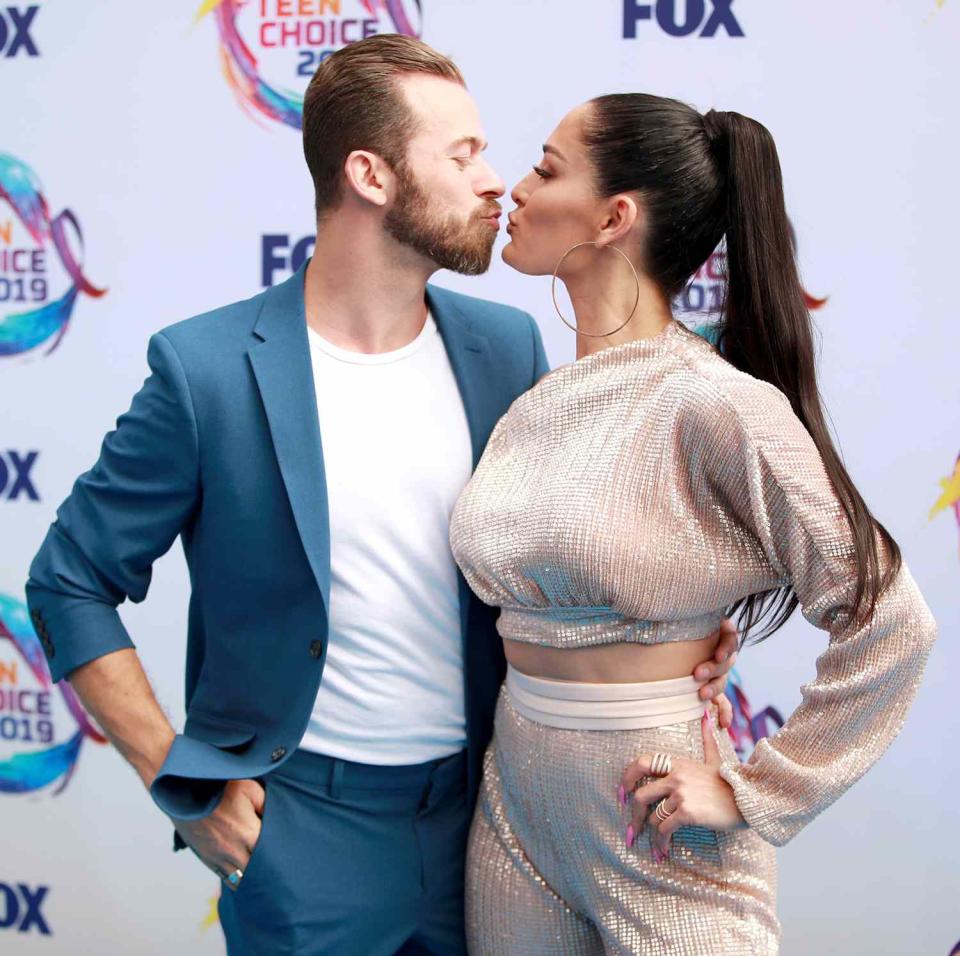 Artem Chigvintsev and Nikki Bella attend FOX's Teen Choice Awards 2019 on August 11, 2019 in Hermosa Beach, California