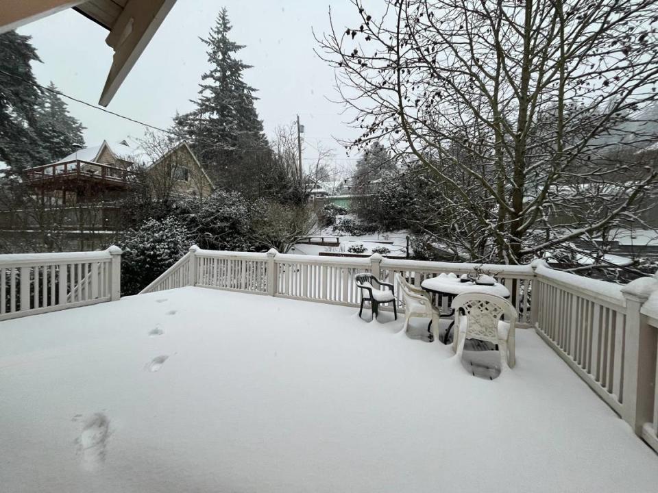 Several inches of snow cover a backyard porch on January 17, 2024, in Bellingham, Wash.