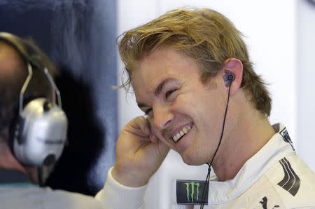 Mercedes Formula One driver Nico Rosberg of Germany smiles as he prepares for the first free practice session of the Hungarian Grand Prix at the Hungaroring circuit, near Budapest July 25, 2014. REUTERS/David W Cerny