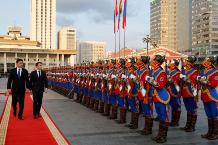 Mongolian President Uhunagiin Khurelsukh and French Emmanuel Macron inspect the honor guard