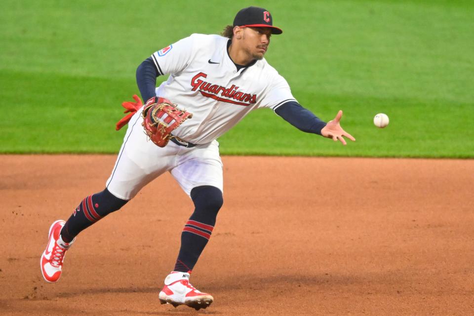 Cleveland Guardians first baseman Josh Naylor (22) tosses the ball to first base in the seventh inning against the New York Yankees on Saturday in Cleveland.