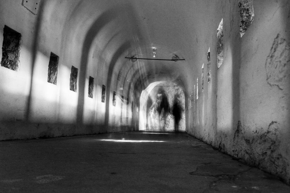 A black and white image of a long hallway
