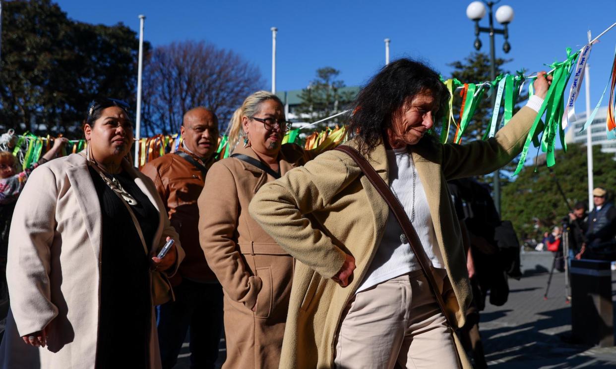 <span>People arrive at parliament in New Zealand ahead of the release of a landmark report detailing the extent of abuse in state and faith-based care.</span><span>Photograph: Hagen Hopkins/Getty Images</span>