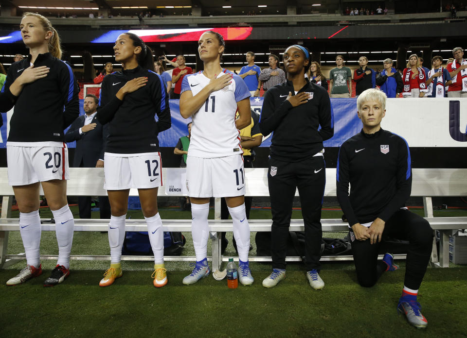 Megan Rapinoe, right, kneels next to teammates Samanth Mewis (20) Christen Press (12), Ali Krieger (11), Crystal Dunn (16) and Ashlyn Harris (22) during the national anthem before an exhibition match against the Netherlands in 2016 in Atlanta.