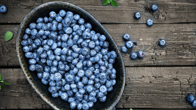 bowl of blueberries on wooden table