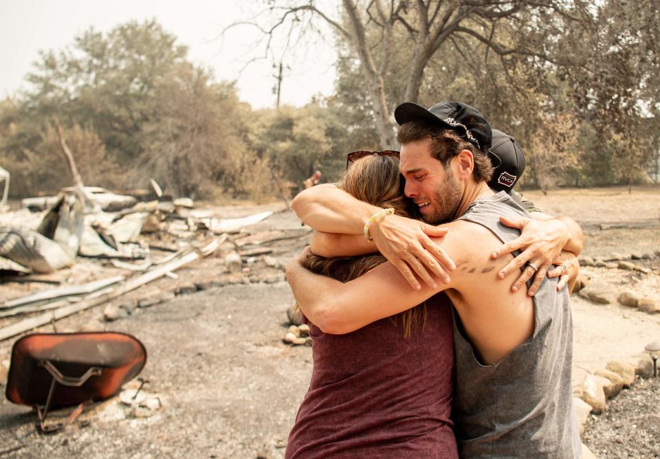 Austin Giannuzzi cries while embracing family members at the burned remains of their home during the LNU Lightning Complex Fire in Vacaville, Calif., on Aug. 23.