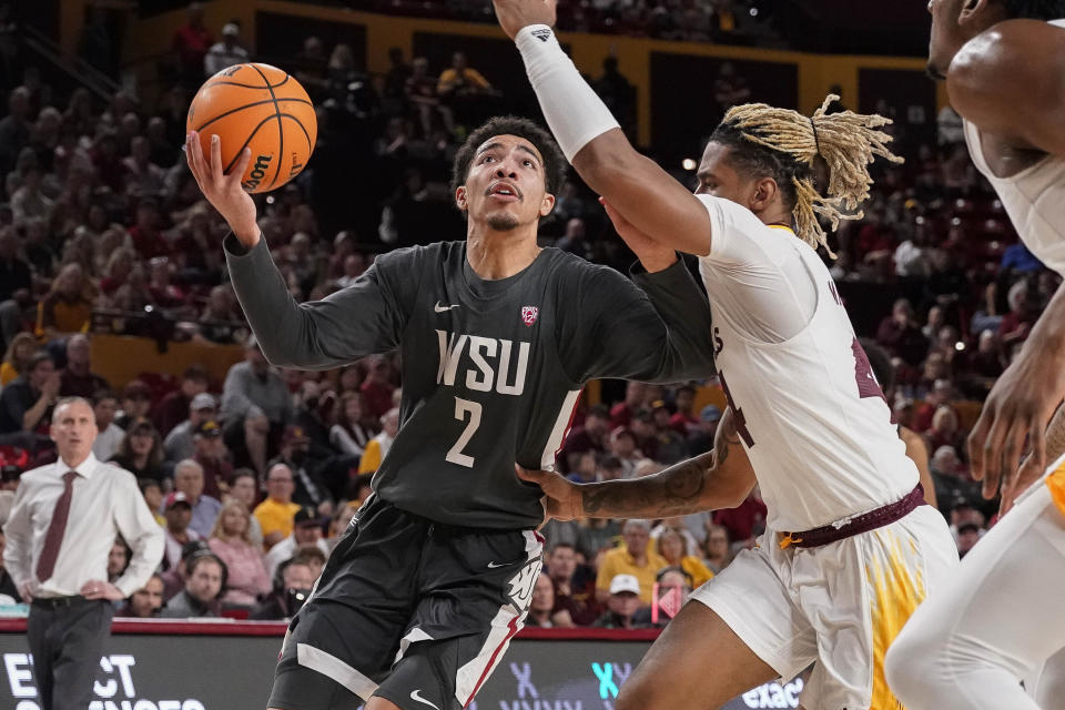 Washington State guard Myles Rice (2) drives to the basket against Arizona State guard Adam Miller (44) during the first half of an NCAA college basketball game Saturday, Feb. 24, 2024, in Tempe, Ariz. (AP Photo/Darryl Webb)