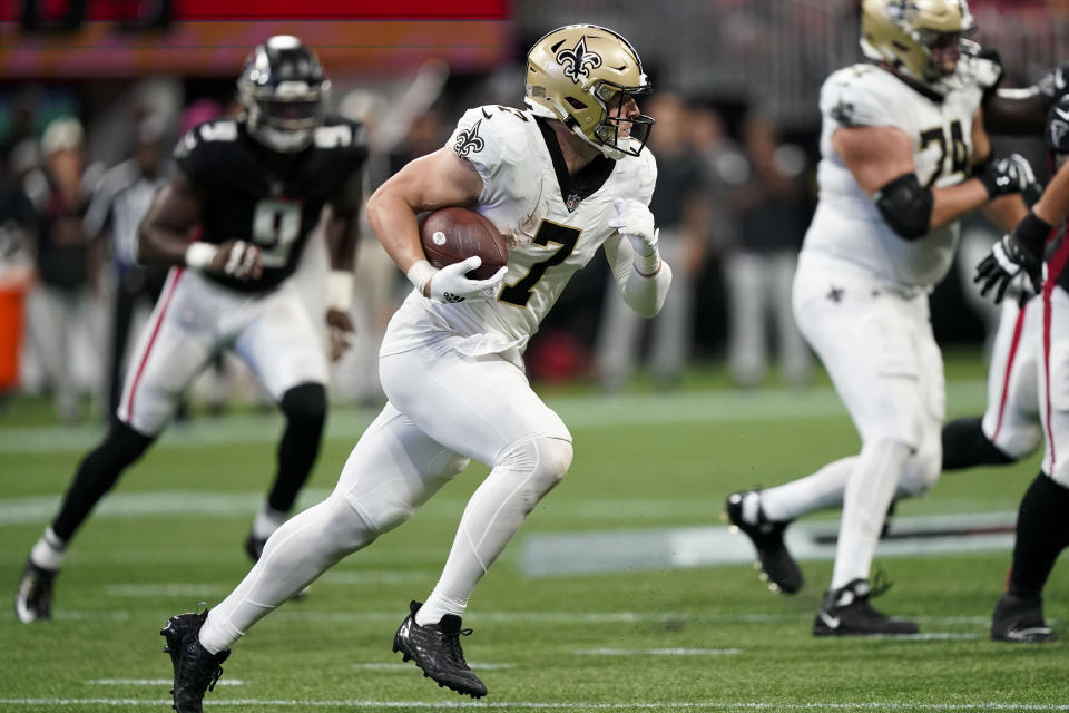 New Orleans Saints tight end Taysom Hill (7) runs after a ctach against the Atlanta Falcons during the second half of an NFL football game, Sunday, Sept. 11, 2022, in Atlanta. (AP Photo/Brynn Anderson)