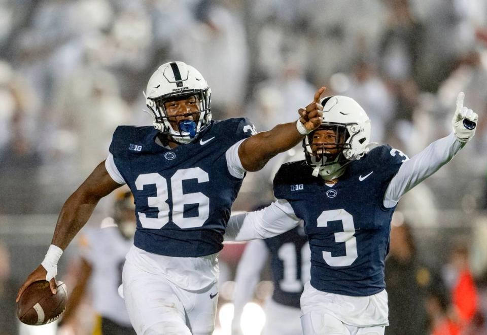 Penn State linebacker Zuriah Fisher and cornerback Johnny Dixon celebrate a play during the game against Iowa on Saturday, Sept. 23, 2023.