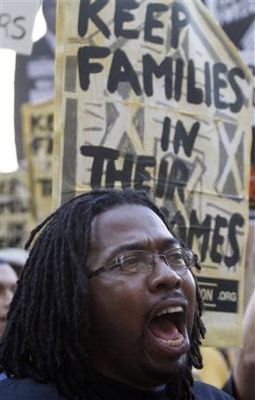 A member of a coalition called "Stand up Chicago" cheers during a protest outside the Mortgage Bankers Association's annual meeting in Chicago October 10, 2011. REUTERS/Frank Polich