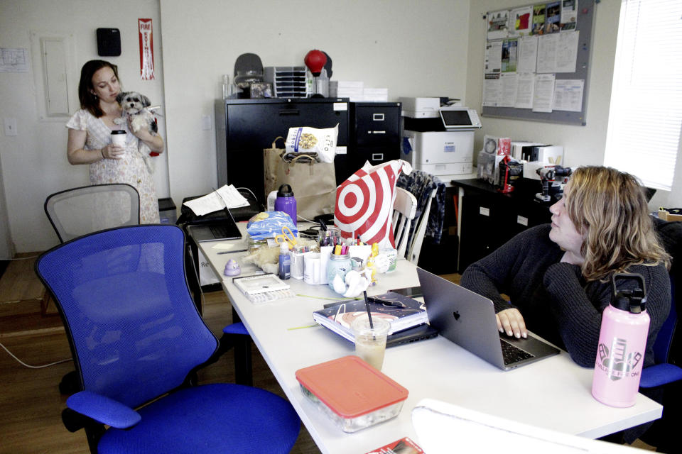 Cassie Trahan, left, co-founder and executive director of A Village for One, speaks with her colleague Ashley Purdy, program operations manager, at their nonprofit in Oregon City, Ore., in this May 4, 2022, photo. Trahan says case dismissals due to an acute shortage of public defenders in Oregon is affecting her clients' mental health as cases against their abusers stall. A post-pandemic glut of delayed cases has exposed shocking constitutional landmines impacting defendants and crime victims alike in Oregon, where an acute shortage of public defenders has even led judges to dismiss serious cases. (AP Photo/Gillian Flaccus)