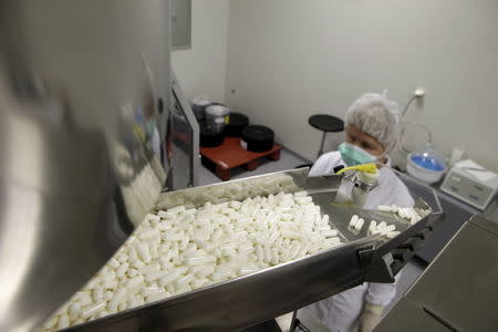 A manufacturing operator works at the Mildronate (Meldonium) medication packaging process in the production plant of the Grindeks pharmaceutical company in Riga, Latvia, November 23, 2010. REUTERS/Ints Kalnins/Files