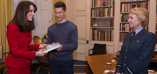 Cadet Sergeant Tommy Dade (centre) stands with the Duchess of Cambridge as she is presented with a book by Air Commodore, Dawn McCafferty Commandant of the Air Cadet organisation. Photo: Getty Images.