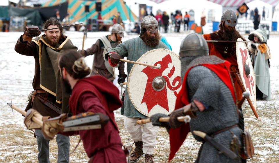 Members of the Viking Vulksgaard, of Ohio, practice fighting before their afternoon show in front of a large crowd during the Michigan Nordic Fire Festival at the Eaton County Fairgrounds in Charlotte on Saturday, Feb. 25, 2023.