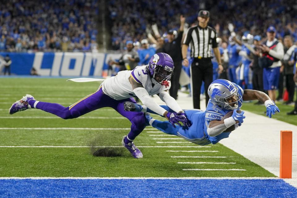 Detroit Lions' Justin Jackson runs past Minnesota Vikings' Cameron Dantzler Sr. for a touchdown during the second half of an NFL football game Sunday, Dec. 11, 2022, in Detroit. (AP Photo/Paul Sancya)
