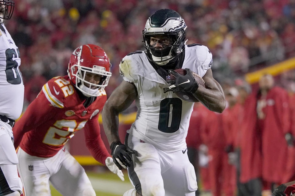 Philadelphia Eagles running back D'Andre Swift (0) runs with the ball as Kansas City Chiefs cornerback Trent McDuffie (22) defends during the first half of an NFL football game, Monday, Nov. 20, 2023, in Kansas City, Mo. (AP Photo/Ed Zurga)