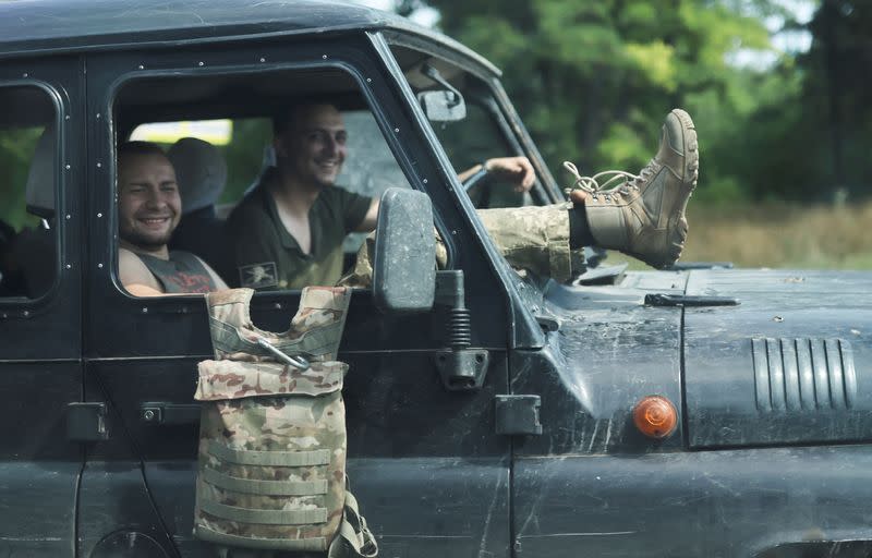 Ukrainian servicemen sit inside a jeep with broken windows in Kramatorsk