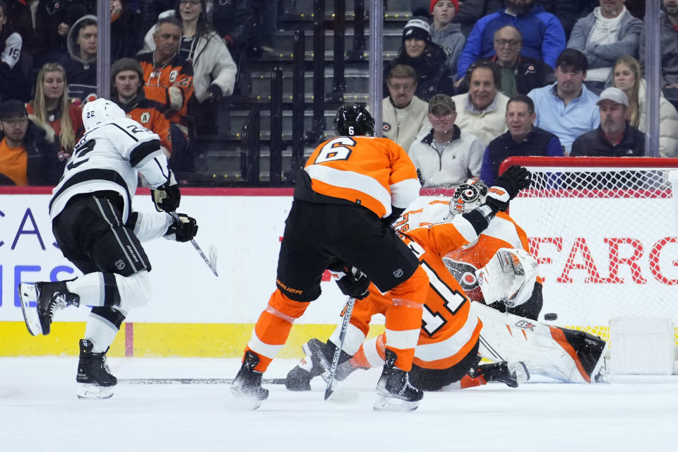 Los Angeles Kings' Kevin Fiala, left, scores the game-winning goal against Philadelphia Flyers' Travis Sanheim, from left, Travis Konecny and Carter Hart during overtime in an NHL hockey game, Tuesday, Jan. 24, 2023, in Philadelphia. (AP Photo/Matt Slocum)