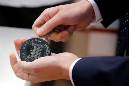 A man opens a box of Rova Caviar during an interview at the Imperial Treasure Restaurant in Paris