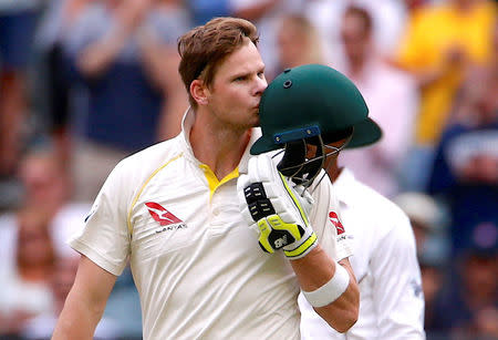 Cricket - Ashes test match - Australia v England - MCG, Melbourne, Australia, December 30, 2017. Australia's captain Steve Smith kisses his helmet after reaching his century during the fifth day of the fourth Ashes cricket test match. REUTERS/David Gray