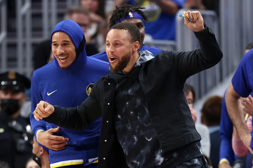 SAN FRANCISCO, CALIFORNIA - APRIL 02:  Stephen Curry #30 and Juan Toscano-Anderson #95 of the Golden State Warriors celebrate on the bench during their game against the Utah Jazz at Chase Center on April 02, 2022 in San Francisco, California. NOTE TO USER: User expressly acknowledges and agrees that, by downloading and/or using this photograph, User is consenting to the terms and conditions of the Getty Images License Agreement.  (Photo by Ezra Shaw/Getty Images)