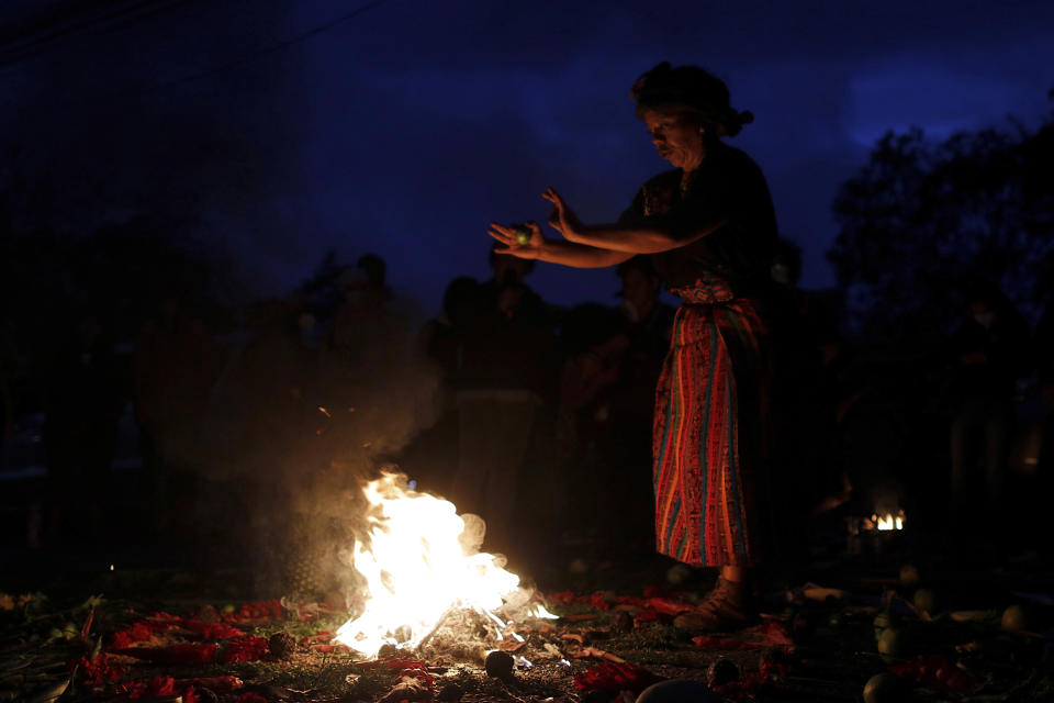 An Indigenous leader prays during a spiritual ceremony before the start of a trial against one of the alleged masterminds of the killing the environmental and Indigenous rights activist Berta Caceres, in Tegucigalpa, Honduras, Monday, April 5, 2021. The trial of Roberto David Castillo is expected to run through April. The government has already convicted seven people in Caceres' murder, but Castillo is considered a potentially critical link to those who ordered it. (AP Photo/Elmer Martinez)