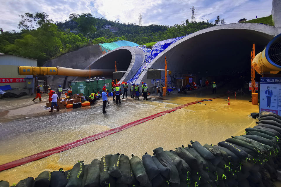 Rescuers build embankments to pump out water from a flooded tunnel in Zhuhai city in south China's Guangdong province Friday, July 16, 2021. Divers have been dispatched in the search for 14 workers missing since water flooded a tunnel under construction in southern China three days ago, authorities said Sunday, July 18, 2021. (Chinatopix via AP)