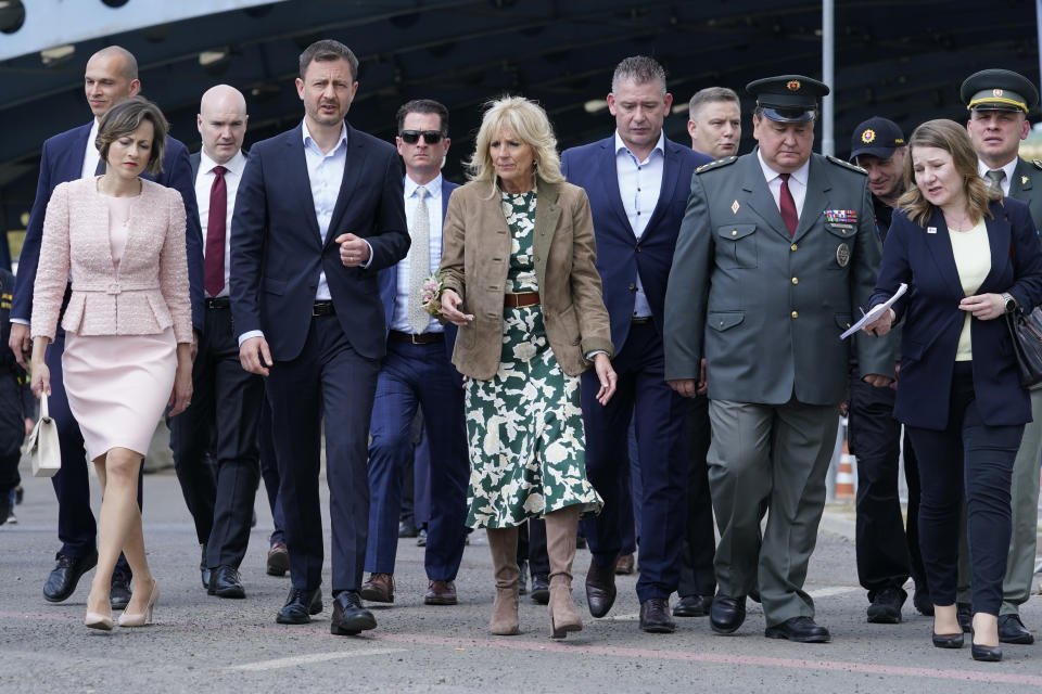 First lady Jill Biden speaks with Slovakia's Prime Minister Eduard Heger as she walks from Vysne Nemecke, Slovakia, towards the border with Ukraine, red line, during a visit Sunday, May 8, 2022. (AP Photo/Susan Walsh, Pool)