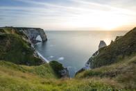<p>The cliffs and natural arches of Etretat in Noramdie, France. </p>