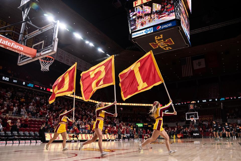 Iowa State cheerleaders fire up the crowd before the Cyclones' women's basketball game against Jacksonville on Dec. 11 at Hilton Coliseum in Ames. Hilton will be silent this week after the university on Tuesday announced the cancellations of two basketball games.