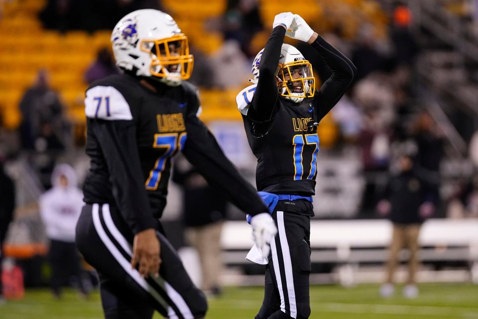 Gahanna Lincoln's Brayden Sanders (right) and Jeremy McDowell celebrate during the second half of the Lions' 25-17 win over New Albany in the Division I, Region 3 final Nov. 18 at Historic Crew Stadium.