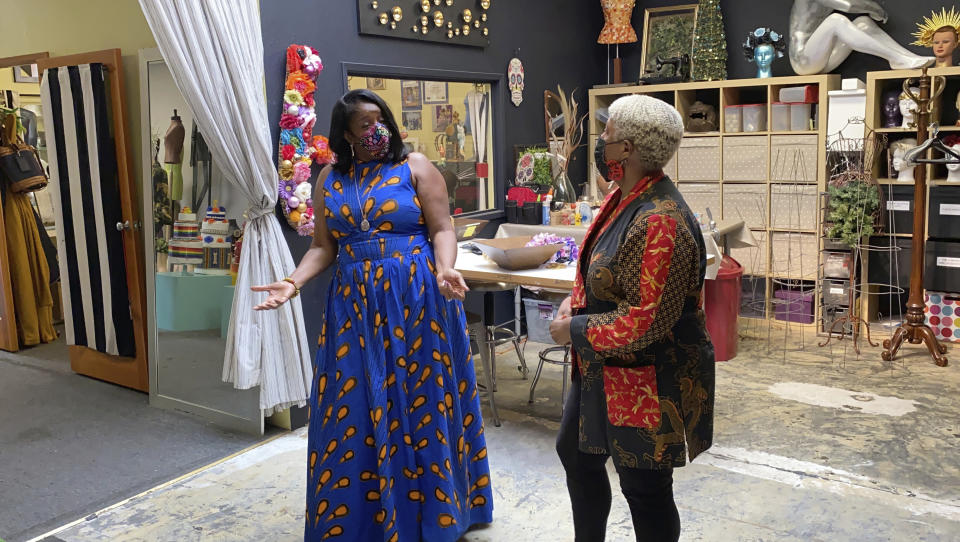 Cathy Adams, left, president of the Oakland African American Chamber of Commerce, speaks with Judi Henderson, owner of Mannequin Madness, Tuesday, Sept. 15, 2020, in Oakland, Calif. The Oakland business received a grant from the chamber's "Resiliency Fund," which seeks to help Black-owned businesses stay afloat during the coronavirus pandemic. (AP Photo/Terry Chea)