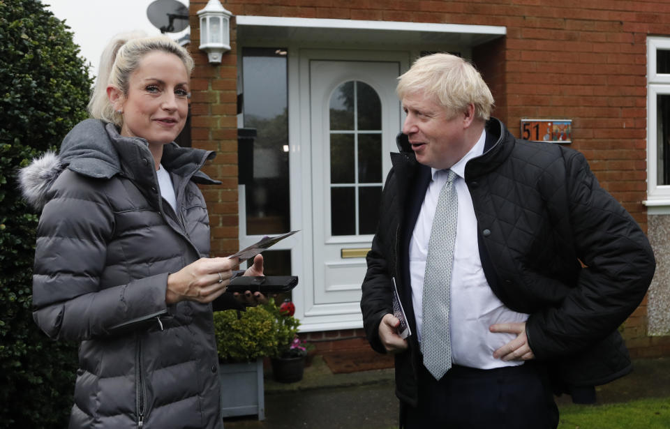 Britain's Prime Minister Boris Johnson, speaks to a voter in the Mansfield constituency as he canvases during a General Election campaign trail stop in Mansfield, England, Saturday, Nov. 16, 2019.Britain goes to the polls on Dec.12. (AP Photo/Frank Augstein, Pool)