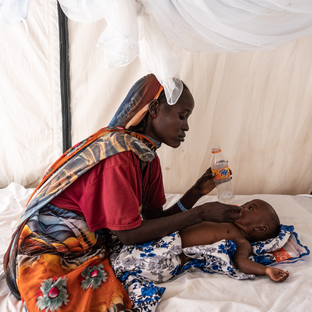  Nadifa Mohamed Adam, 22, gives water to his child who is suffering from fever and malnutrition at the malaria department tent in the Doctors Without Borders clinic inside the Adre camp, where around 200,000 people are currently taking refuge on September 19, 2023 in Adre, Chad. The conflict in Sudan, entering its sixth month, has left thousands of civilians dead and displaced more than five million people. More than 420,000 people have already found refuge in neighbouring Chad as hundreds continue to arrive daily. . 
