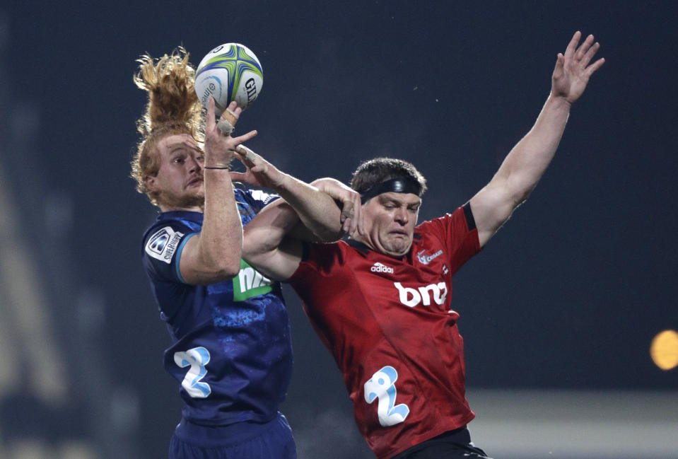 Blues Tom Robinson, left, and Crusaders Scott Barrett battle for the ball during their Super Rugby match in Christchurch, New Zealand, Saturday, May 25, 2019. (AP Photo/Mark Baker)