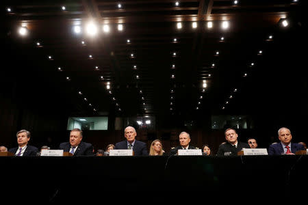 Federal Bureau of Investigation (FBI) Director Christopher Wray; Central Intelligence Agency (CIA) Director Mike Pompeo; Director of National Intelligence (DNI) Dan Coats; Defense Intelligence Agency Director Robert Ashley; National Security Agency (NSA) Director Michael Rogers; and National Geospatial Intelligence Agency Director Robert Cardillo testify before a Senate Intelligence Committee hearing on "World Wide Threats" on Capitol Hill in Washington, U.S., February 13, 2018. REUTERS/Leah Millis