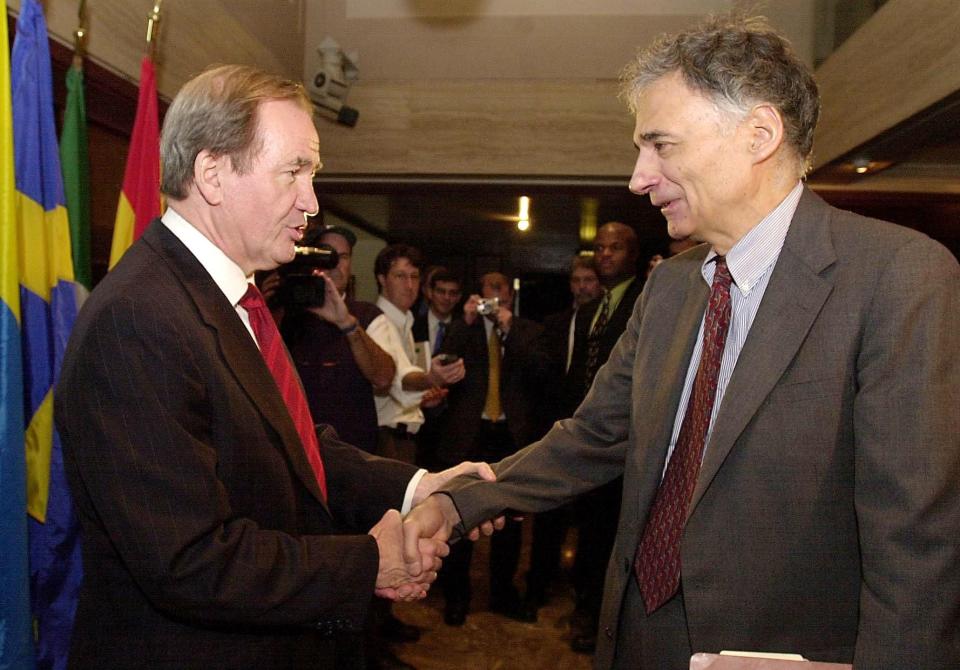 Green Party presidential candidate Ralph Nader (R) is congratulated by Reform Party presidential candidate Pat Buchanan between press conferences on Nov. 8, 2000 at the National Press Club in Washington, DC. (JOYCE NALTCHAYAN/AFP via Getty Images)