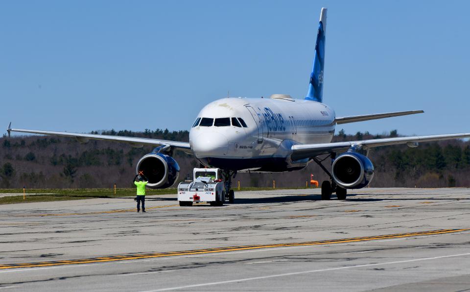 A JetBlue jet taxis on the runway prior to taking off at Worcester Regional Airport.