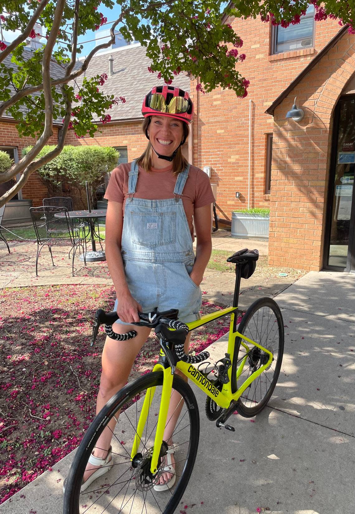 Emily Newsom, who competed in the Tour de France Femmes, cycles around Fort Worth on her canary yellow Cannondale.