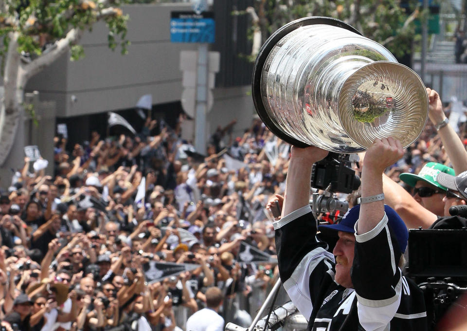 LOS ANGELES, CA - JUNE 14: Matt Greene #2 of the Los Angeles Kings holds up the Stanley Cup to the fans during the Los Angeles Kings Stanley Cup Victory Parade on June 14, 2012 in Los Angeles, California. (Photo by Victor Decolongon/Getty Images)
