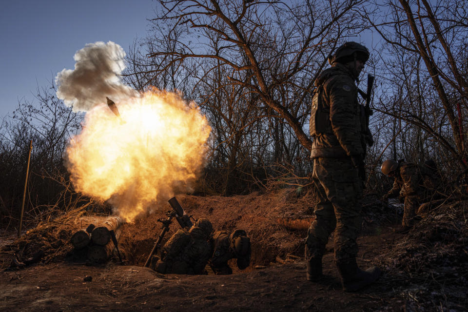 FILE - Ukrainian servicemen fire a 120mm mortar towards Russian positions at the frontline near Bakhmut, Donetsk region, Ukraine, Wednesday, Jan. 11, 2023. Ukrainian President Volodymyr Zelenskyy said Sunday, May 21, 2023 that Russian forces weren't occupying Bakhmut, casting doubt on Moscow's insistence that the eastern Ukrainian city had fallen. The fog of war made it impossible to confirm the situation on the ground in the invasion’s longest battle, and the comments from Ukrainian and Russian officials added confusion to the matter. (AP Photo/Evgeniy Maloletka, File)