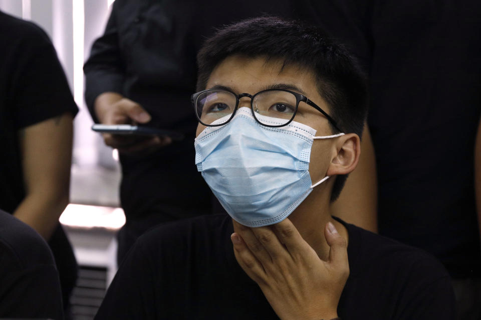 Joshua Wong, a pro-democracy activist who was elected from unofficial pro-democracy primaries, with others attend a press conference in Hong Kong, Wednesday, July 15, 2020. Young activists and localist candidates dominated Hong Kong's unofficial pro-democracy primaries over the weekend, with hundreds of thousands of people voting despite warnings the election could violate the territory's new security law imposed by Beijing. (AP Photo/Kin Cheung)