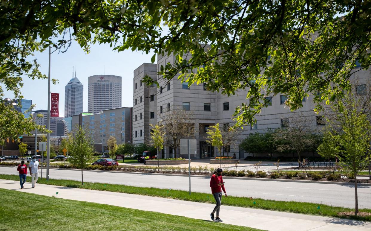 Students walk the campus of IUPUI near the Informatics and Communications Technology Complex in Indianapolis on Tuesday, April 27, 2021.