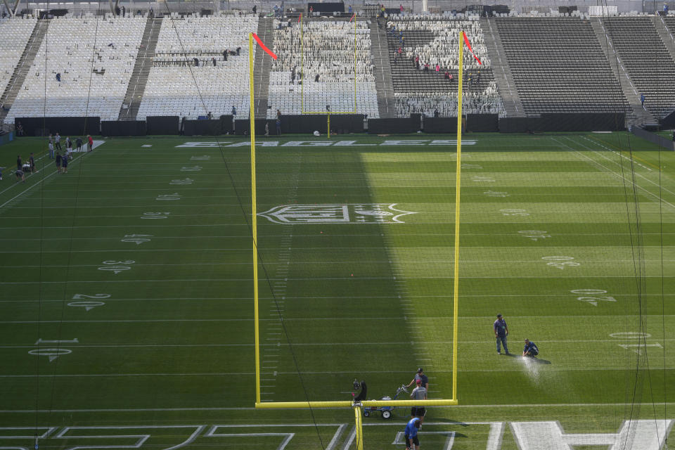 Men work to prepare the Soccer Neo Química Arena in Sao Paulo, Wednesday, Sept. 4, 2024, as Brazil prepares to host its first ever NFL match on Sept. 6, 2024, between the Green Bay Packers and the Philadelphia Eagles. (AP Photo/Andre Penner)