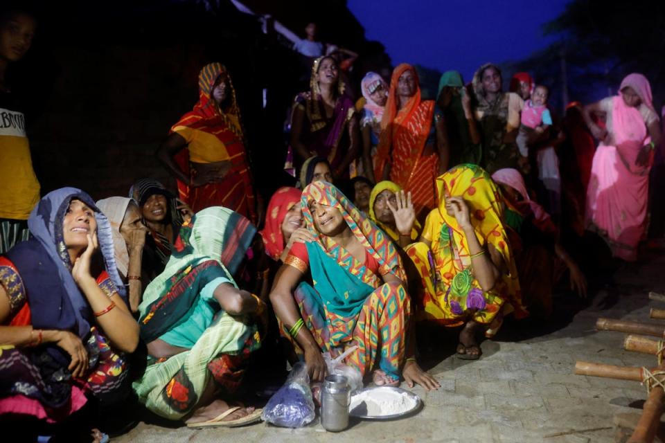 Relatives mourn victims of the stampede victims at Daunkeli village in Hathras, Uttar Pradesh (Reuters)