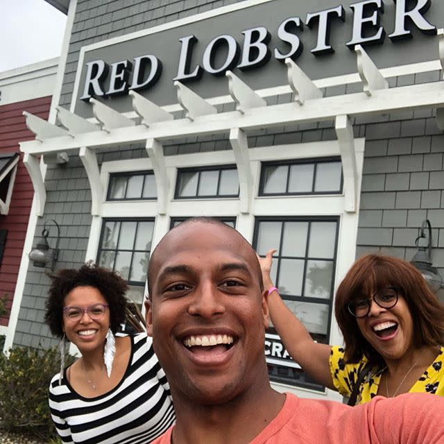 a group of people posing for the camera in front of a building