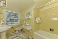 <p><span>1058 Fraser Ave., London, Ont.</span><br> There are three-and-a-half bathrooms, including this one with vintage tile.<br> (Photo: Zoocasa) </p>