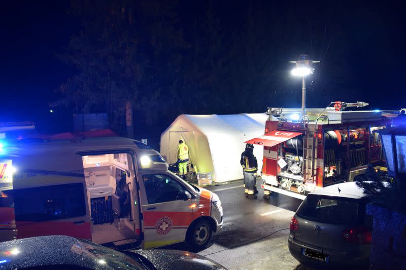 Ambulance and fire crews work at the scene where a male driver of a car hit a group of German tourists, killing six in Lutago