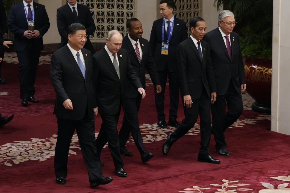 Chinese President Xi Jinping, Russian President Vladimir Putin, Ethiopian Prime Minister Abiy Ahmed, Indonesian President Joko Widodo and Kazakhstan President Kassym-Jomart Tokayev head to a group photo session at the third Belt and Road forum on Oct. 18, 2023, in Beijing. <a href="https://www.gettyimages.com/detail/news-photo/chinese-president-xi-jinping-russian-president-vladimir-news-photo/1730510539?adppopup=true" rel="nofollow noopener" target="_blank" data-ylk="slk:Photo by Suo Takekuma-Pool/Getty Images;elm:context_link;itc:0;sec:content-canvas" class="link ">Photo by Suo Takekuma-Pool/Getty Images</a>