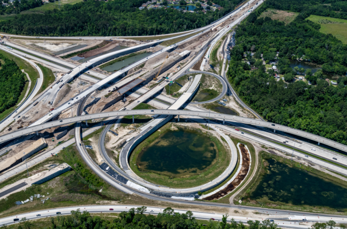 An aerial photo taken during construction of the new interchange connecting Interstate 95 and Interstate 295 on the Northside of Jacksonville shows the series of interlocking bridges and ramps that form the busy highway junction. The project started in late 2016 and the latest delay will push completion to spring 2025.